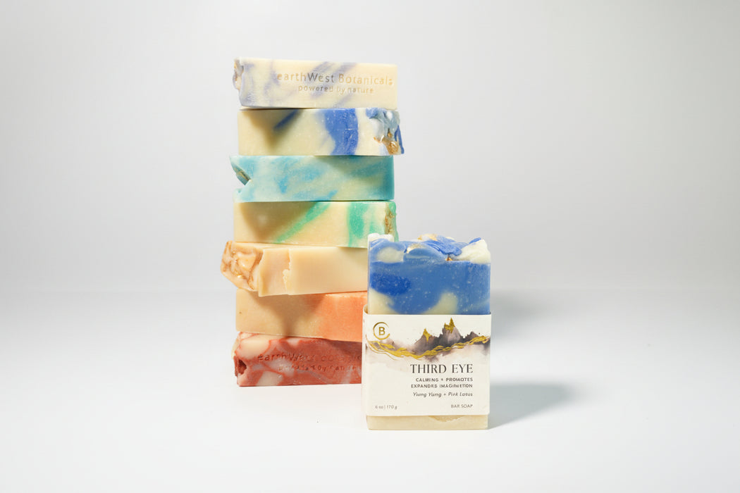 Stack of colorful soap bars with a single labeled Third Eye bar soap a gray background