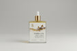 Bottle of Third Eye body oil with a gold dropper on a dark surface.