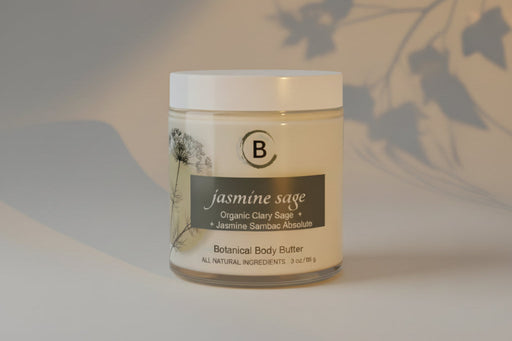 Jar of jasmine sage botanical body butter on a light gray background