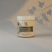 Jar of jasmine sage botanical body butter on a light gray background
