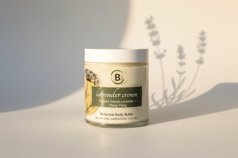 Jar of lavender-scented body butter on a marble surface with a light gray background