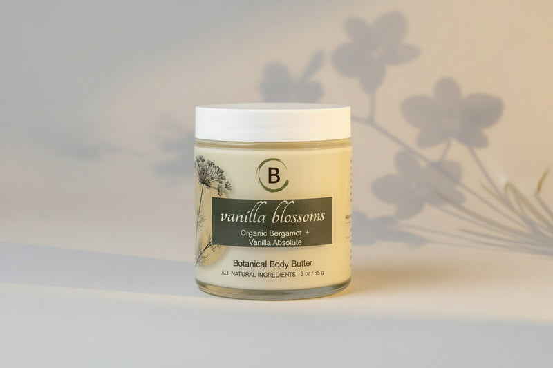 Jar of vanilla blossoms organic body butter on a light gray background