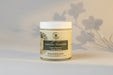Jar of vanilla blossoms organic body butter on a light gray background